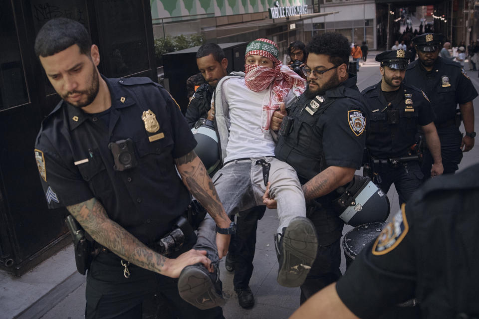 Police arrest a protester during a pro-Palestinian demonstration calling for an economic blockade and demanding a cease-fire on the Israel-Palestinian conflict outside The New York Stock Exchange on Monday, April 15, 2024, in New York. (AP Photo/Andres Kudacki)