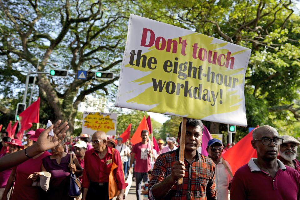 Members of National People's Power, a political alliance, carry placards at a Labour Day rally in Colombo, Sri Lanka, Wednesday, May 1, 2024. (AP Photo/Eranga Jayawardena)