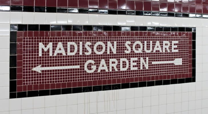 A photo of a Madison Square Garden sign with an arrow.