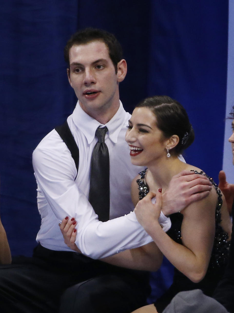 Marissa Castelli and Simon Shnapir react as scores are posted after skating in the pairs free skate at the U.S. Figure Skating Championships in Boston, Saturday, Jan. 11, 2014. (AP Photo/Elise Amendola)