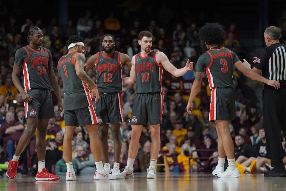Ohio State center Felix Okpara (34), guard Roddy Gayle Jr. (1), guard Evan Mahaffey (12), forward Jamison Battle (10) and guard Taison Chatman (3) stand on the court during the second half of an NCAA college basketball game against Minnesota, Thursday, Feb. 22, 2024, in Minneapolis. (AP Photo/Abbie Parr)