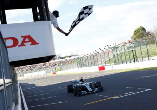 Mercedes' British driver Lewis Hamilton crosses the finish line to win the 2018 Japanese Grand Prix in Suzuka. This year's qualifying on Saturday could moved to Sunday as Typhoon Hagibis bears down on Japan