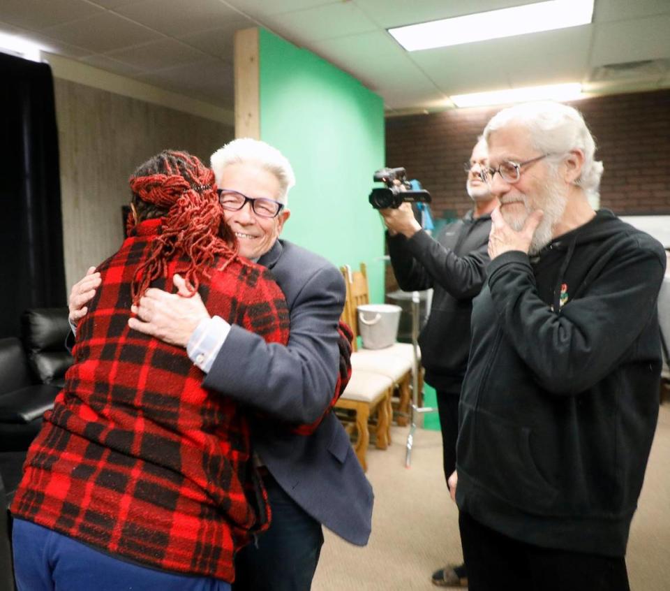 Shawntel Anderson and Bob Hopkins embraced Saturday in Dallas as Bob Whisnant looked on. Hopkins and Whisnant found Anderson abandoned in Kansas City in 1982 when she was about eight months old.