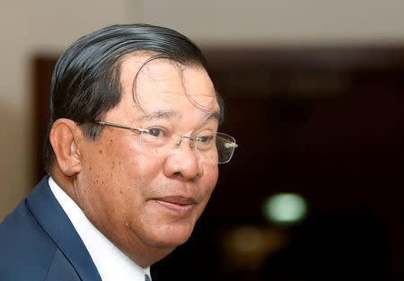 FILE PHOTO - Cambodia's Prime Minister Hun Sen smiles as he arrive at the National Assembly of Cambodia during a plenary session, in central Phnom Penh, February 20, 2017. REUTERS/Samrang Pring/File Photo