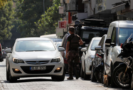 A policeman checks a car outside the home of U.S. pastor Andrew Brunson in Izmir, Turkey August 16, 2018. REUTERS/Osman Orsal