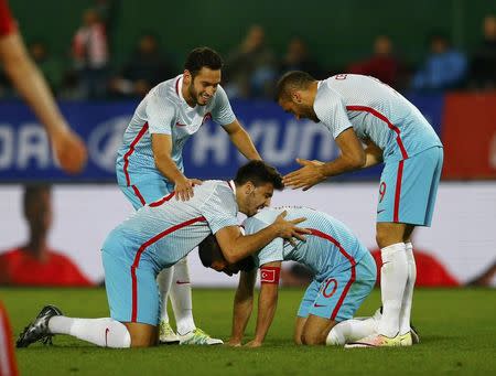 Football Soccer - Austria v Turkey - International friendly - Ernst Happel stadium, Vienna, Austria - 29/03/16. Turkey's Ozan Tufan, Hakan Calhanoglu, Arda Turan and Cenk Tosun react REUTERS/Leonhard Foeger