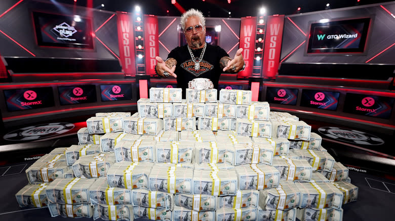 Guy Fieri poses with cash