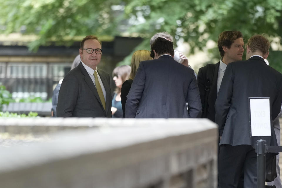 Actor Kevin Spacey, left, waits in the queue to go into Southwark Crown Court in London, Friday, June 30, 2023. Spacey is going on trial on charges he sexually assaulted four men as long as two decades ago. The double-Oscar winner faces a dozen charges at Southwark Crown Court. Spacey pleads not guilty to all charges. (AP Photo/Kin Cheung)