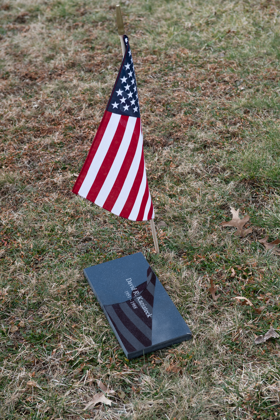 A new headstone temporarily rests in the grass by the grave of David Kaziateck in Hawley Cemetery in Paris Township. It is expected to be installed in a few months.