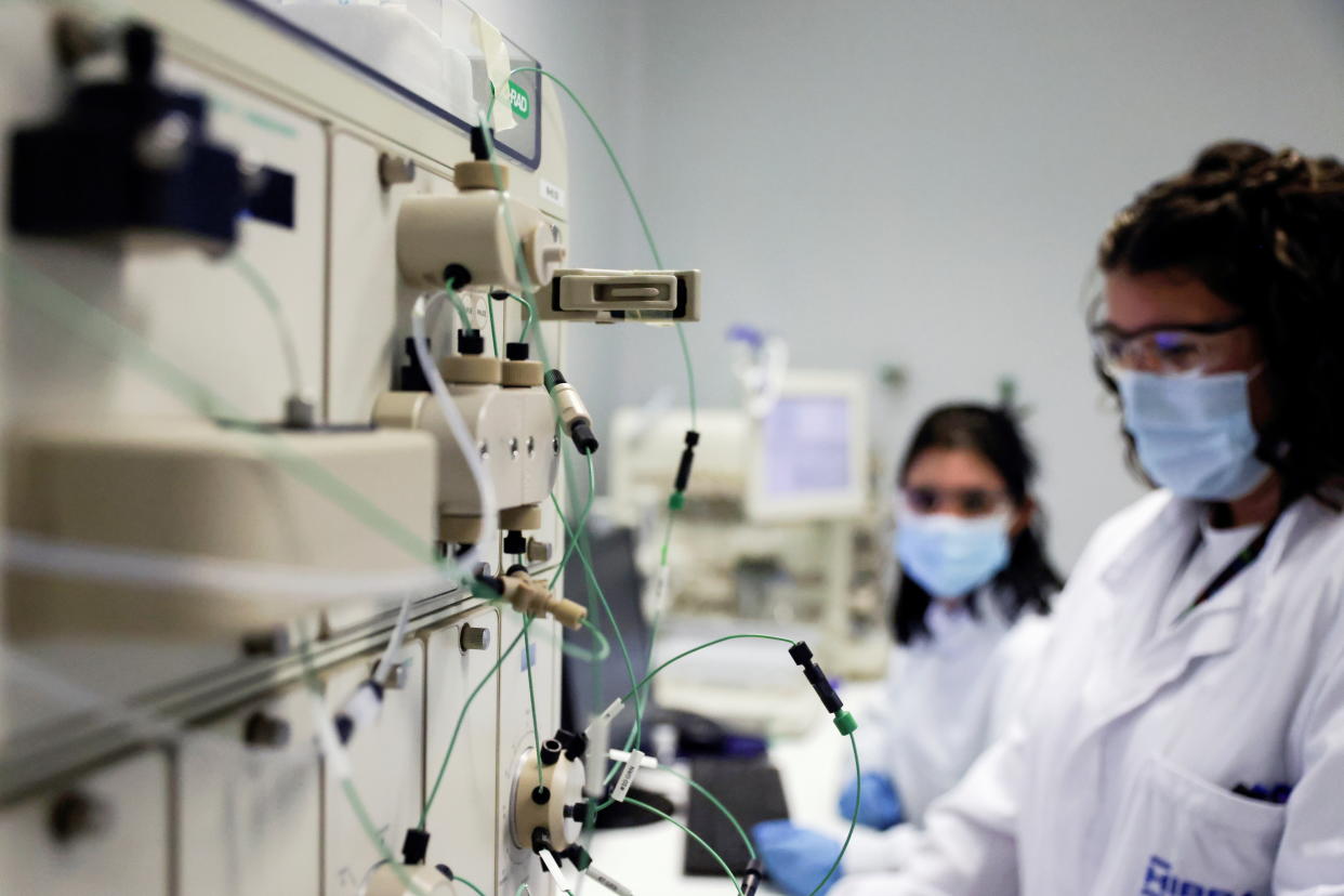 Lab employees of Spanish pharmaceutical company Hipra work at its headquarters in Amer, near Girona, Spain, December 2, 2021. Picture taken December 2, 2021. REUTERS/Nacho Doce