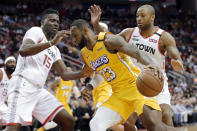 Los Angeles Lakers forward LeBron James (23) drives in front of Houston Rockets center Clint Capela (15) and forward PJ Tucker during the first half of an NBA basketball game Saturday, Jan. 18, 2020, in Houston. (AP Photo/Michael Wyke)
