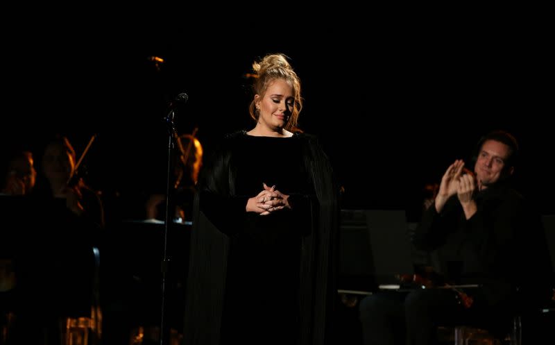 FILE PHOTO: Singer Adele is applauded as he finishes her tribute to the late George Michael at the 59th Annual Grammy Awards in Los Angeles