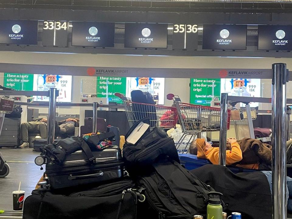 Stranded travelers sleep at Keflavik International Airport in Reykjavík, Iceland, in December 2022.