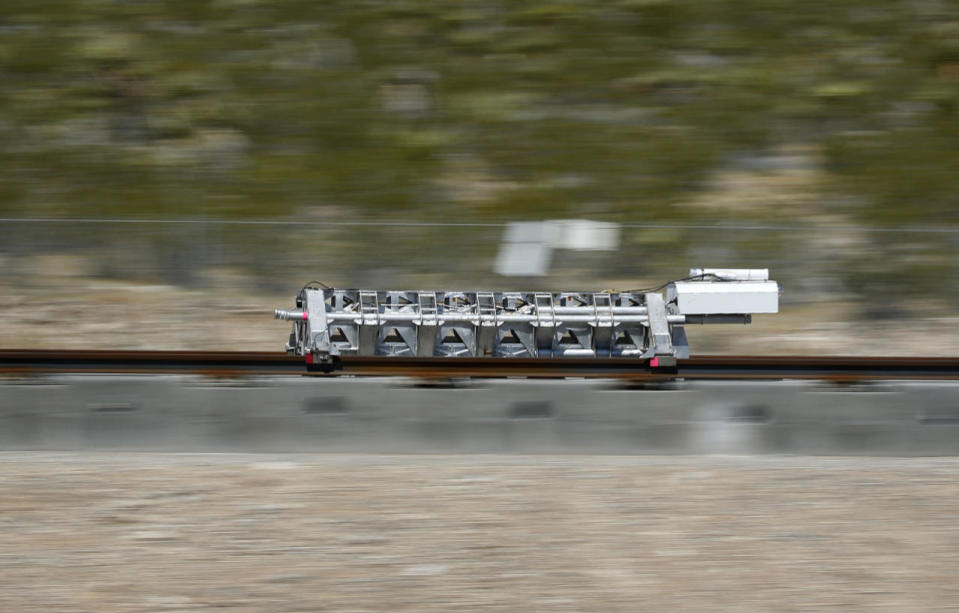 A sled speeds down a track during a test of a Hyperloop One propulsion system, Wednesday, May 11, 2016, in North Las Vegas, Nev. (AP Photo/John Locher)