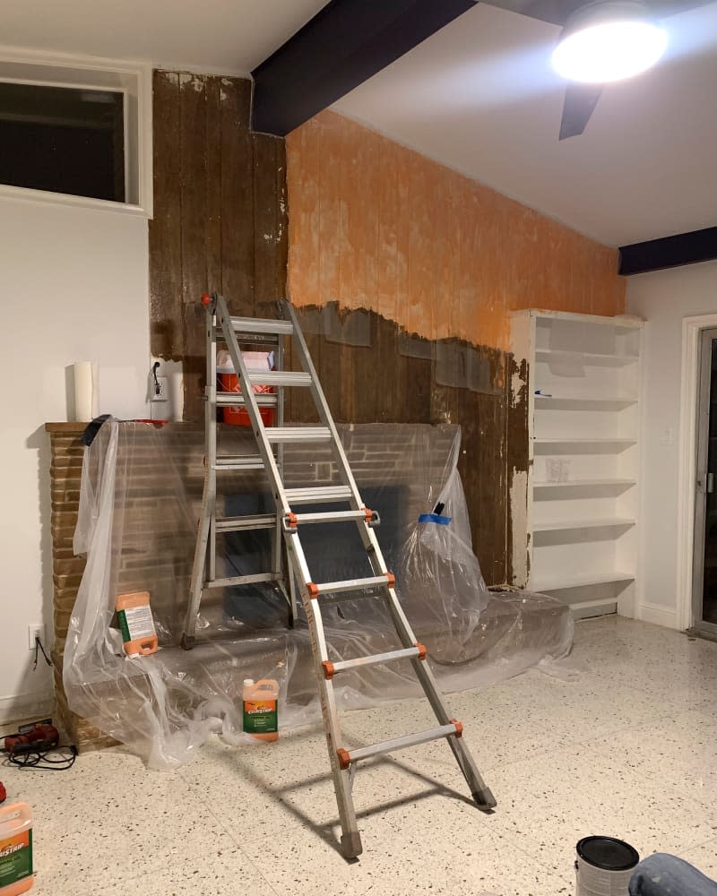 Wood panels above fireplace during renovation.