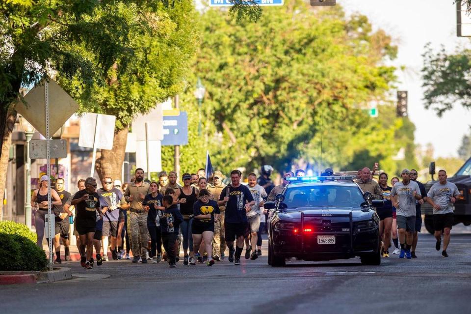 Participants in the Law Enforcement Torch Run for Special Olympics Northern California make their way along West Main Street in Merced, Calif., on Thursday, June 15, 2023. Andrew Kuhn/akuhn@mercedsun-star.com