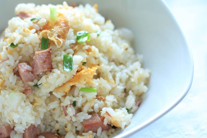 A close up of spiced ham and egg fried rice.