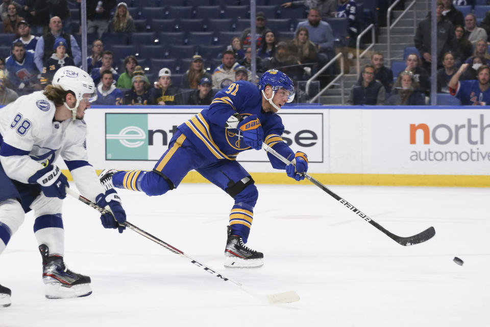 Buffalo Sabres center Drake Caggiula (91) shoots and scores a goal while defended by Tampa Bay Lightning defenseman Mikhail Sergachev (98) during the second period of an NHL hockey game Monday, Oct. 25, 2021, in Buffalo, N.Y. (AP Photo/Joshua Bessex)