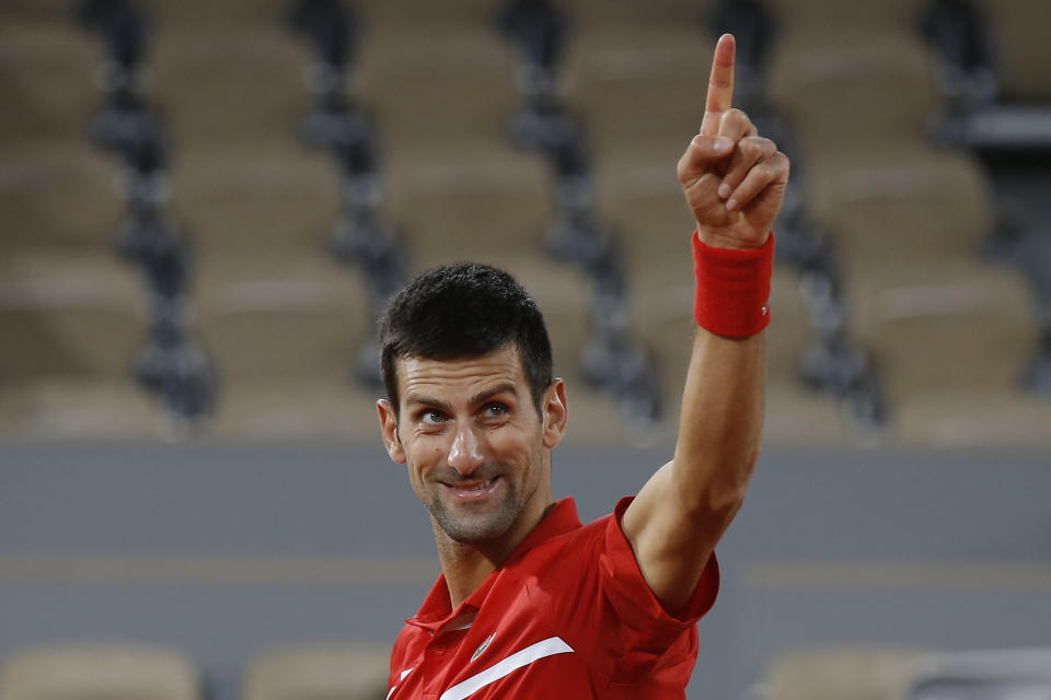 Serbia's Novak Djokovic celebrates winning his semifinal match of the French Open tennis tournament against Greece's Stefanos Tsitsipas in five sets, 6-3, 6-2, 5-7, 4-6, 6-1, at the Roland Garros stadium in Paris, France, Friday, Oct. 9, 2020. (AP Photo/Michel Euler)