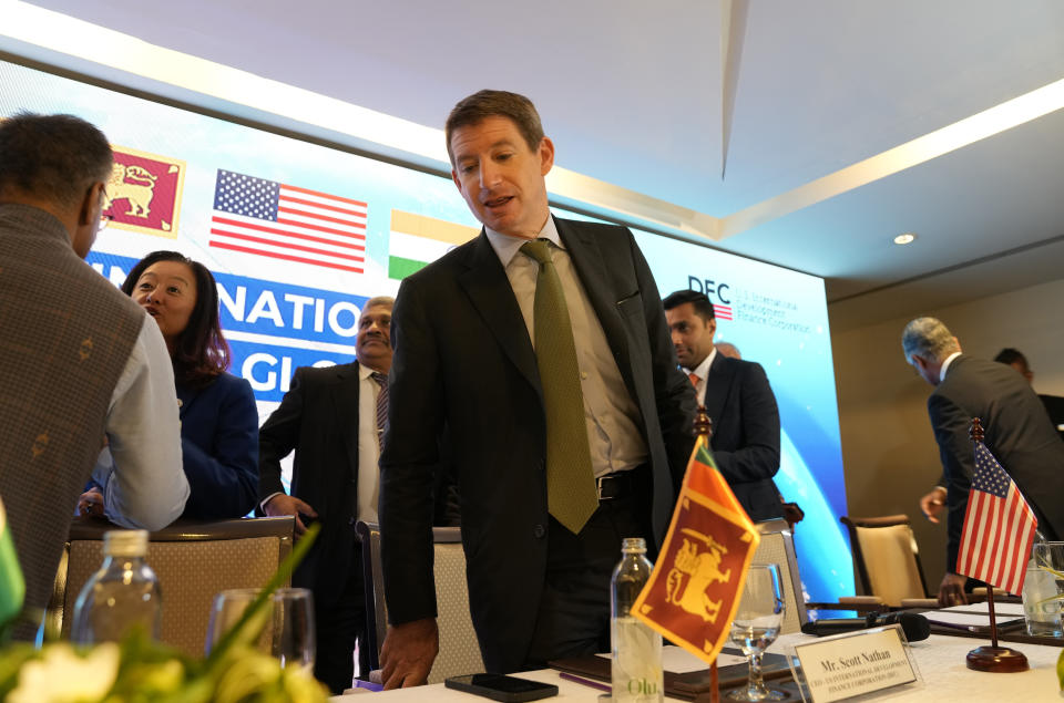 U.S. International Development Finance Corporation (DFC) Chief Executive Officer Scott Nathan, center, prepares to leave after making a statement in Colombo, Sri Lanka, Wednesday, Nov.8, 2023. The U.S. announced a $553- million project Wednesday to build a new, deep-water shipping container terminal in the Port of Colombo as it competes with China in international development financing. (AP Photo/Eranga Jayawardena)