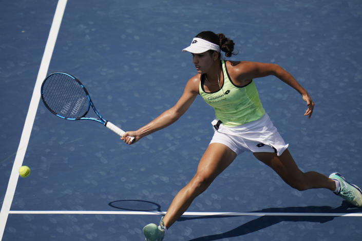 Camila Osorio, of Colombia, reaches to return a shot during a match against Emma Raducanu, of Britain, at the Citi Open tennis tournament in Washington, Thursday, Aug. 4, 2022. (AP Photo/Carolyn Kaster)