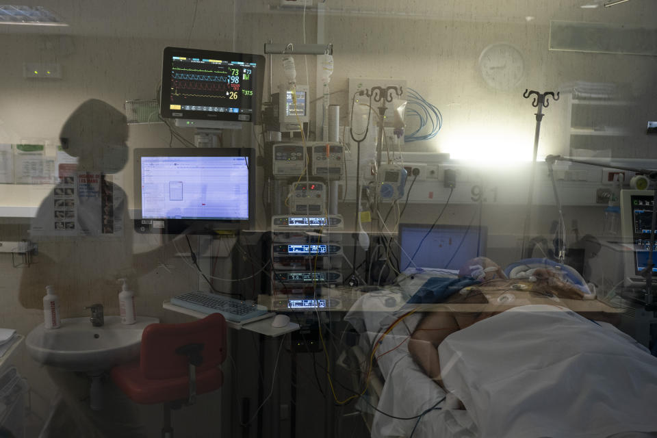 A COVID-19 patient undergoes treatment in one of the intensive care units (ICU) of the Germans Trias i Pujol hospital in Badalona, Barcelona province, Spain, Wednesday, April 1, 2020. The new coronavirus causes mild or moderate symptoms for most people, but for some, especially older adults and people with existing health problems, it can cause more severe illness or death. (AP Photo/Felipe Dana)