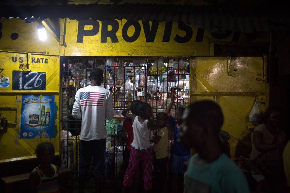 Patrons line up at a shop in the West Point community of Liberia's capital. More Than Me was created to educate girls who are from this community, many of whom are at risk of sexual exploitation. | Kathleen Flynn, special to ProPublica