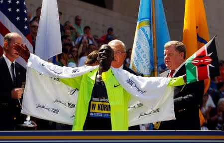 Wesley Korir of Kenya reacts as he gets his medal after winning the men's division of the 116th Boston Marathon in Boston, Massachusetts April 16, 2012. REUTERS/Brian Snyder