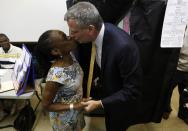 New York City Democratic mayoral candidate Bill di Blasio receives a kiss from his wife Chirlane McCray after voting in the Democratic primary election in the Brooklyn borough of New York, September 10, 2013. (REUTERS/Brendan McDermid)