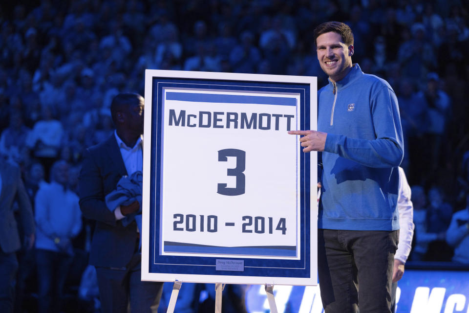 Former Creighton basketball player Doug McDermott points to his framed jersey number during a ceremony marking the retirement of his jersey number, before an NCAA college basketball game between Creighton and Villanova on Wednesday, Dec. 20, 2023, in Omaha, Neb. (AP Photo/Rebecca S. Gratz)