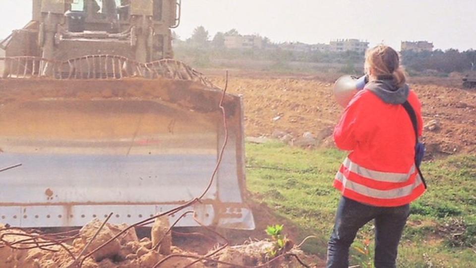 Corrie pictured hours before her death in front of a bulldozer. She and fellow activists were trying to prevent demolition of Palestinian homes (Video screen grab)