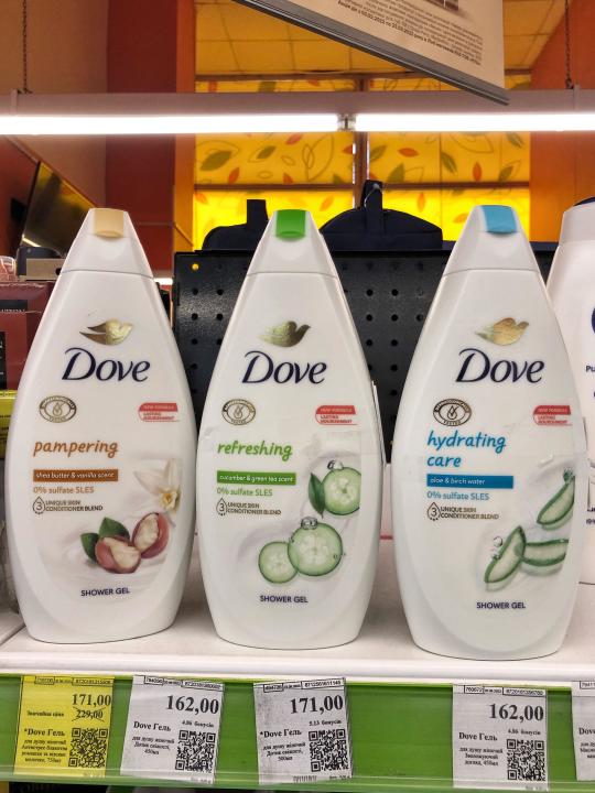 01.10.2023 Ukraine, Kharkov Large range of Dove brand shower gels on the shelves of a cosmetic store