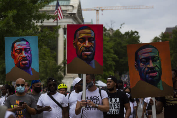 Protesters march with signs for George Floyd during the 57th Annual March on Washington, Friday, August 28, 2020 in Washington, DC, Maryland.  Also called the Get Off Our Necks march, this year's march focused on the recent Black Lives Matter movement while commemorating the work of former civil rights leaders.  (Photo by Erin Lefevre/NurPhoto via Getty Images)