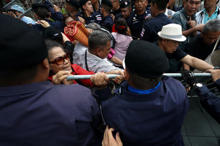 Anti-government protesters confront riot police officers during a protest to demand that the military government hold a general election by November, in Bangkok, Thailand, May 22, 2018. REUTERS/Athit Perawongmetha