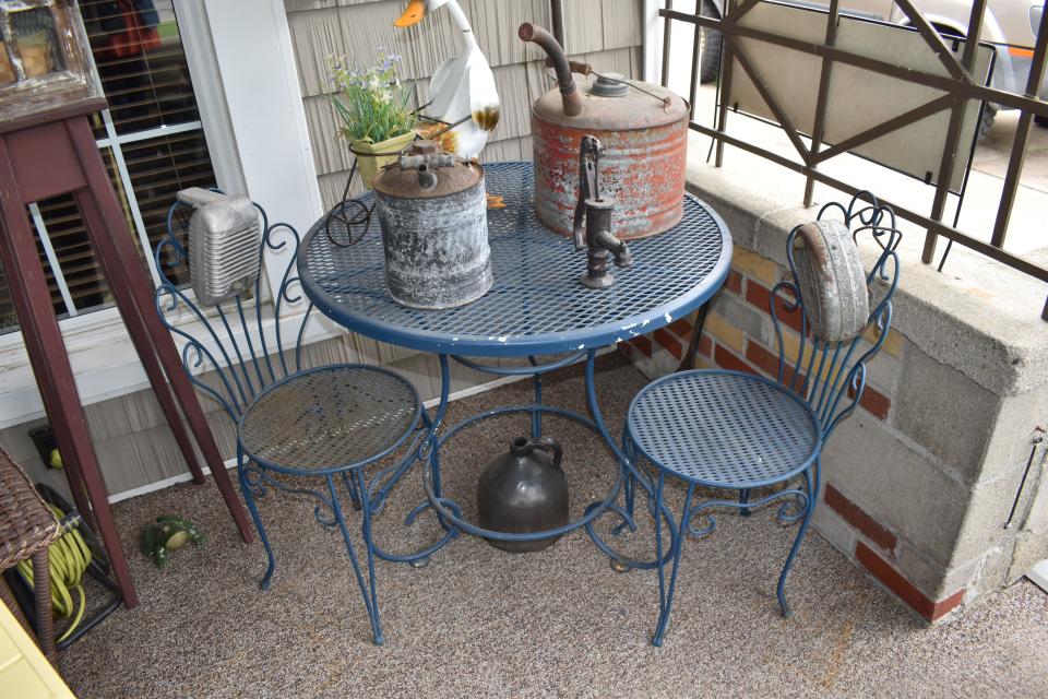 Besides keeping up a colorful and vibrant garden at her home at 158 Budlong St. in Adrian, Kim Baumea also has a knack for finding automotive items such as old gas cans, gas station signs, hubcaps and drive-in movie theater speakers, all of which are situated and placed throughout her garden and on her front porch.