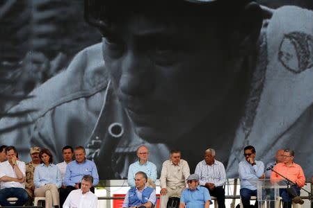 Colombia's Marxist FARC rebel leader Rodrigo Londono, also known as Timochenko, Colombian president Juan Manuel Santos and Jean Arnault, the UN Secretary-General's Special Representative for Colombia and Head of the UN Mission to Colombia, attend the final act of abandonment of arms in Mesetas, Colombia June 27, 2017. REUTERS/Jaime Saldarriaga