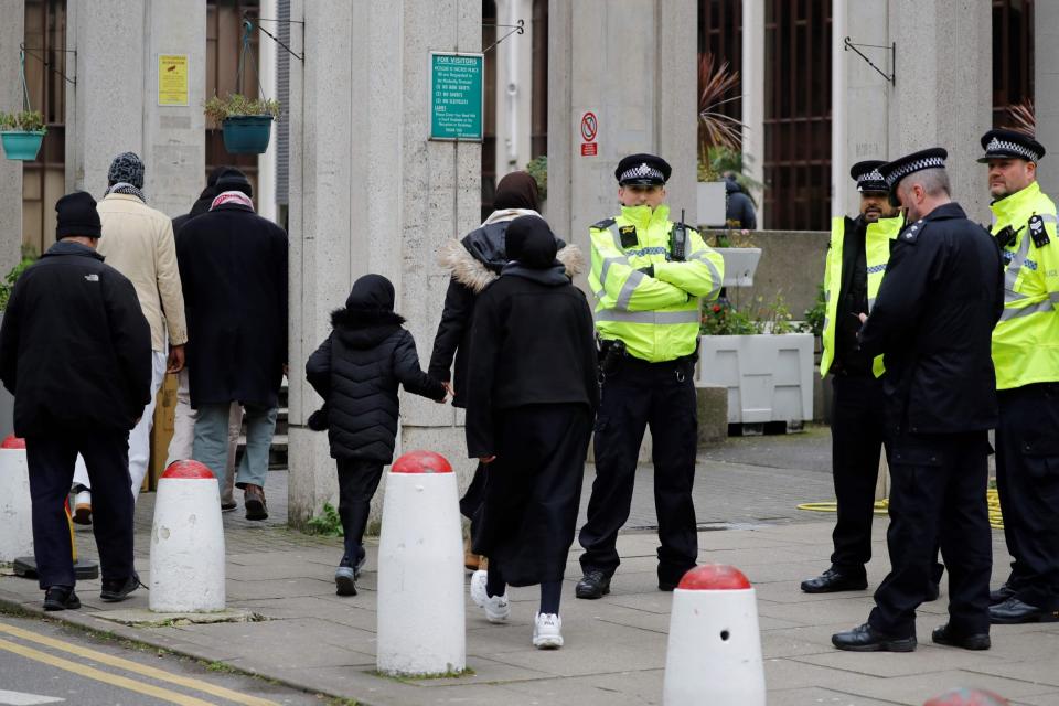 Police officers stand guard as worshippers arrive for Friday Prayers (AFP via Getty Images)