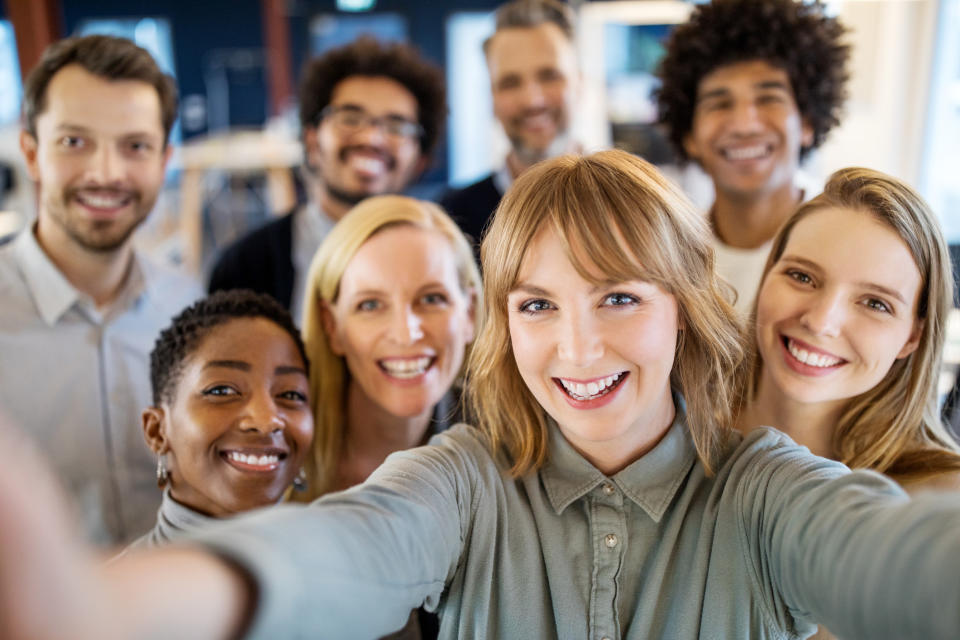 A group of workers taking a selfie