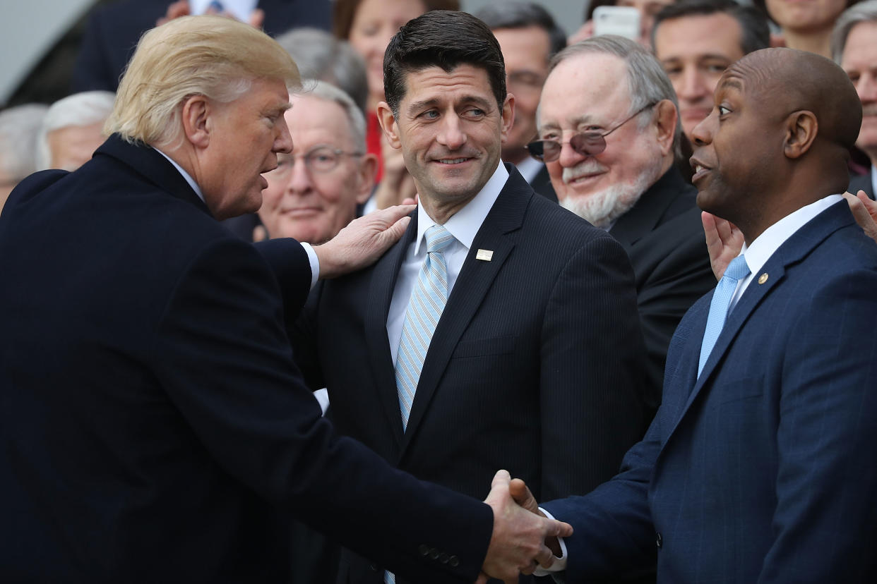 WASHINGTON, DC - DECEMBER 20:  U.S. President Donald Trump (L) congratulates Speaker of the House Paul Ryan (R-WI) (C) and Sen. Tim Scott (R-SC) during an event to celebrate Congress passing the Tax Cuts and Jobs Act with Republican members of the House and Senate on the South Lawn of the White House December 20, 2017 in Washington, DC. The tax bill is the first major legislative victory for the GOP-controlled Congress and Trump since he took office almost one year ago.  (Photo by Chip Somodevilla/Getty Images)