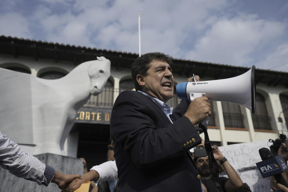 FILE - Presidential candidate Carlos Pineda of the Prosperidad Ciudadana party speaks into a bullhorn after arriving at the Constitutional Court in Guatemala City on Saturday, May 20, 2023. Pineda has sent an "open letter" video to El Salvador´s President Nayib Bukele praising many of the president's most controversial measures. "I have the goal of doing in Guatemala exactly what you are doing in El Salvador," he said. (AP Photo/Moises Castillo, File)