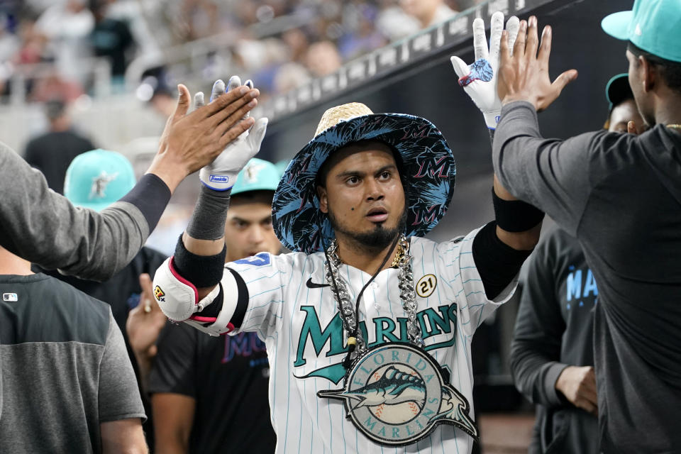 Miami Marlins' Luis Arraez is congratulated after hitting a solo home run during the seventh inning of a baseball game against the Atlanta Braves, Friday, Sept. 15, 2023, in Miami. (AP Photo/Lynne Sladky)