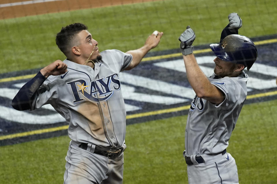 Tampa Bay Rays' Brandon Lowe, right, celebrates his a two-run home run with Willy Adames against the Los Angeles Dodgers during the fifth inning in Game 2 of the baseball World Series Wednesday, Oct. 21, 2020, in Arlington, Texas. (AP Photo/Tony Gutierrez)