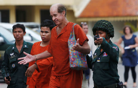 FILE PHOTO - Australian filmmaker James Ricketson (centre R) walks to the Supreme Court in Phnom Penh, Cambodia, January 17, 2018. REUTERS/Samrang Pring