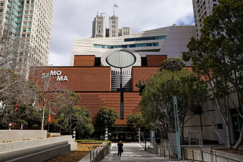 A view of the facade of SFMOMA bearing the name of the museum on red brick