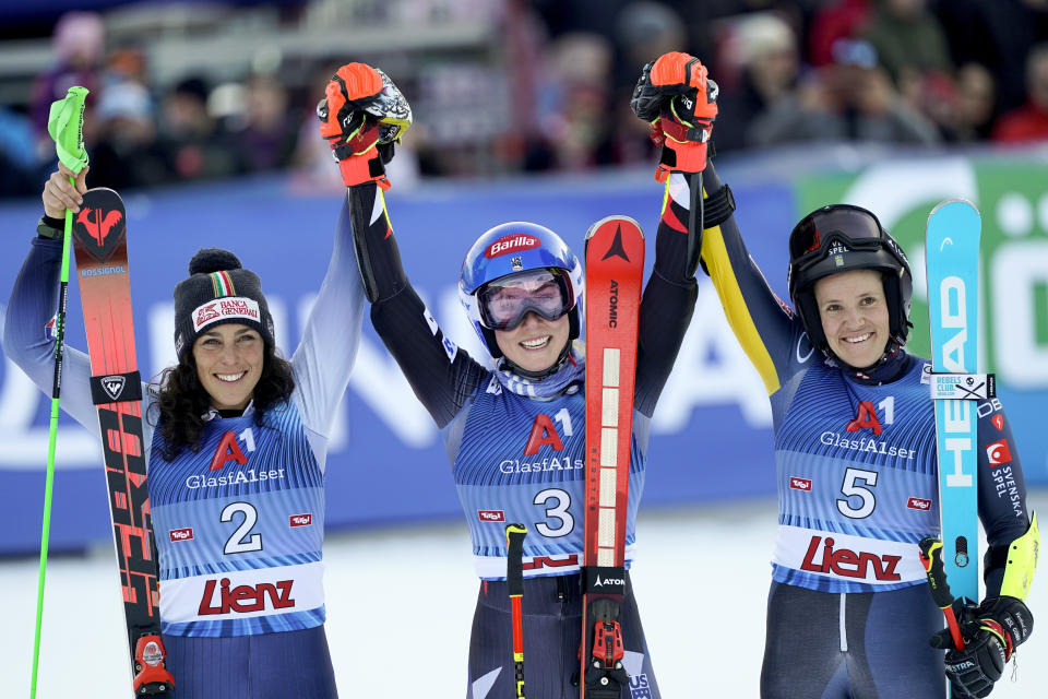 United States' Mikaela Shiffrin, center, winner of an alpine ski, women's World Cup giant slalom race, celebrates with second-placed Italy's Federica Brignone, left, and third-placed Sweden's Sara Hector, in Lienz, Austria, Thursday, Dec. 28, 2023. (AP Photo/Giovanni Auletta)