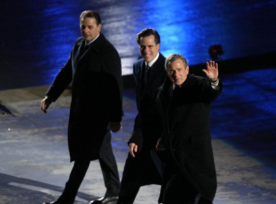 International Olympic Committee President Dr. Jacques Rogge, left, Salt Lake Organizing Committee President Mitt Romney and U.S. President George W. Bush wave to the crowd before moving to their seats during the Salt Lake 2002 Winter Games opening ceremony at the University of Utah’s Rice-Eccles Stadium on Friday, Feb 8, 2002. | Tom Smart, Deseret News