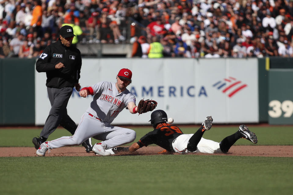 San Francisco Giants' Thairo Estrada, right, steals second base against Cincinnati Reds shortstop Kyle Farmer, center, during the fourth inning of a baseball game in San Francisco, Saturday, June 25, 2022. (AP Photo/Josie Lepe)