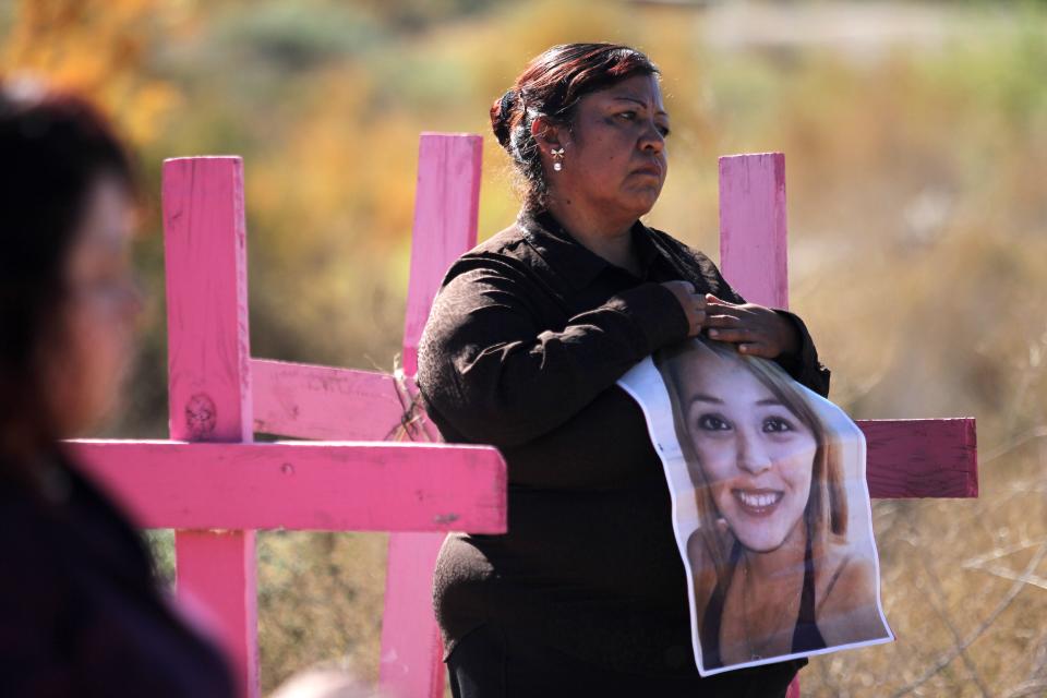 <p>Carmen Castillo (R) holds a picture of her daughter Monica Delgado -killed in 2012- during a protest on the eve of the International Day for the Elimination of Violence Against Women, on Nov. 24, 2017, in Juarez valley, near Ciudad Juarez, Chihuahua State, Mexico. (Photo: Herika Martinez/AFP/Getty Images) </p>