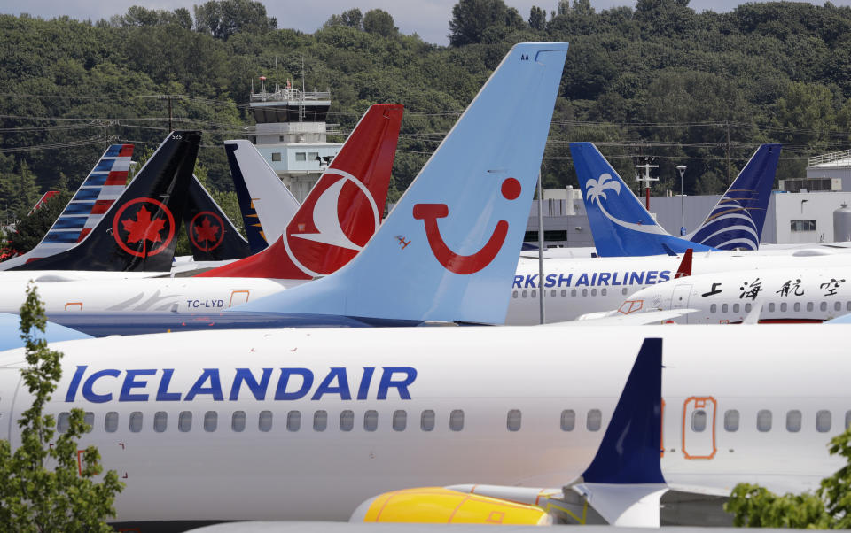 FILE - In this June 27, 2019, file photo dozens of grounded Boeing 737 MAX airplanes crowd a parking area adjacent to Boeing Field in Seattle. Passengers who refuse to fly on a Boeing Max won’t be entitled to compensation if they cancel. However, travel experts think airlines will be very flexible in rebooking passengers of giving them refunds if they’re afraid to fly on a plane that has crashed twice. (AP Photo/Elaine Thompson, File)