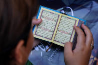 A boy sits on the ground as he reads the Quran during a rally after Friday prayers in the southern Beirut suburb of Dahiyeh, Lebanon, Friday, July 21, 2023. Muslim-majority nations expressed outrage Friday at the desecration of the Islamic holy book in Sweden. Following midday prayers, thousands took to the streets to show their anger, in some cases answering the call of religious and political leaders. (AP Photo/Bilal Hussein)